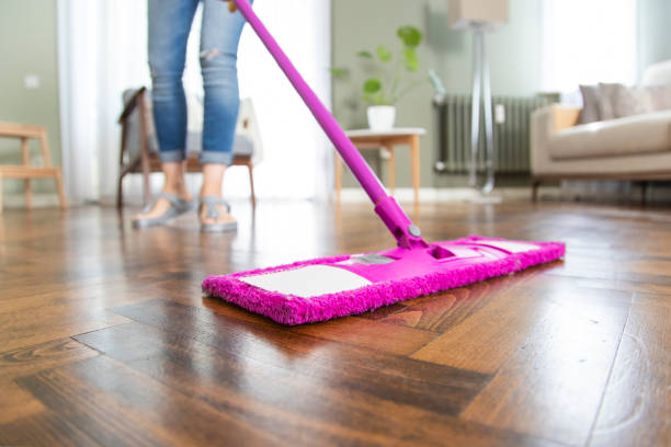 istock Young housewife cleaning wooden parquet using microfiber mop pad 1251347063