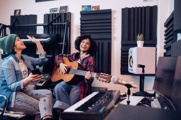 istock Two musicians having fun while recording music in the studio 1251347170