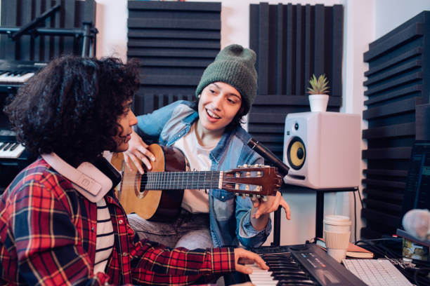 istock Young musicians recording music in the studio 1251347187