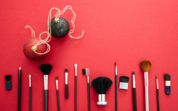 istock Make-up brushes and xmas decoration against red background, copy space 1251347252