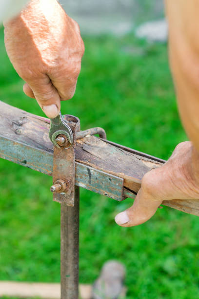 istock Elderly man twists the nut by wrench 1251347255
