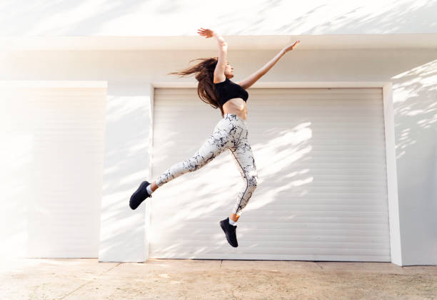 istock Active female jumping high in the air 1251347347