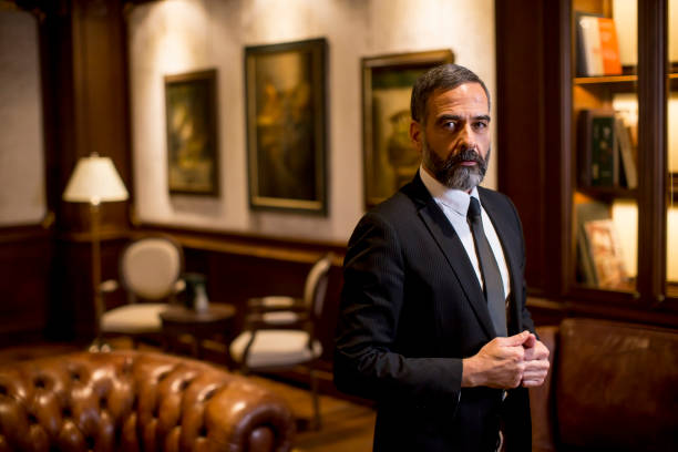 istock Handsome mature man standing at luxurious apartment 1251349060