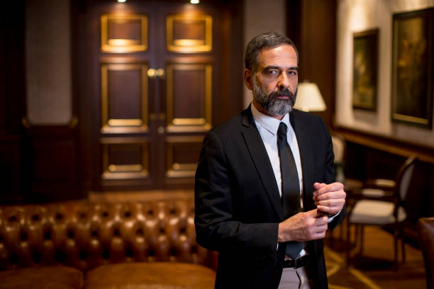 istock Handsome mature man standing at luxurious apartment 1251349066