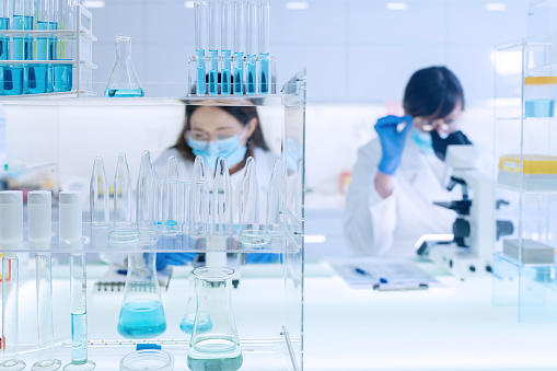 Pathogen Laboratory Female Laboratory Team Working With Pathogen Samples Using Microscope ...