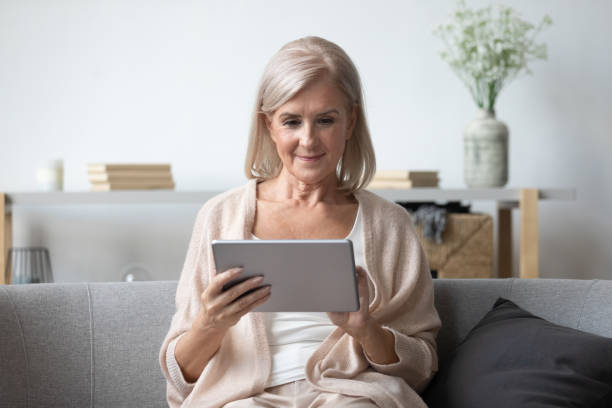 istock Portrait of pleasant middle aged woman using tablet. 1251349940