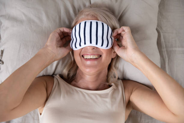 istock Smiling middle aged woman wearing sleeping mask. 1251350004