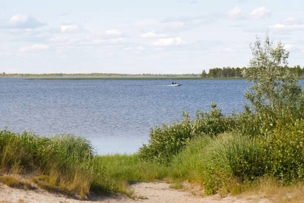 istock Descent to river, motor boat floating on the river. 1251350589