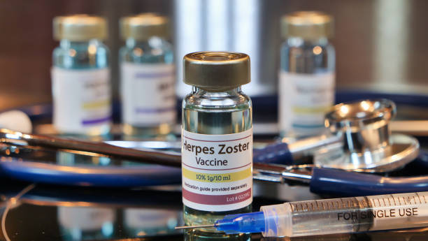 Vial of Herpes Zoster whit syringe and stethoscope on a stainless steel background Vial of Herpes Zoster whit syringe and stethoscope on a stainless steel background herpes stock pictures, royalty-free photos & images