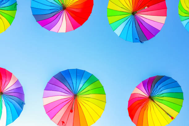 istock colorful umbrellas against the blue sky 1251353435