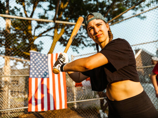 istock Young woman playing softball 1251353498