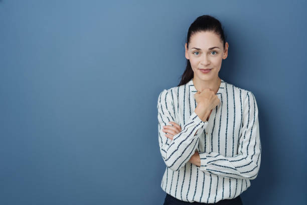 istock Thoughtful young woman smiling at the camera 1251353700