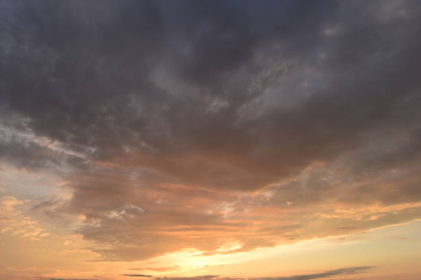 istock Sunlight sunset glowing in the dark blue cloudy sky 1251354033