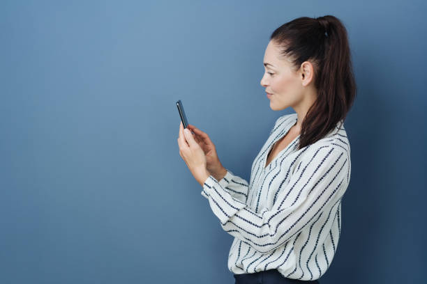 istock Young woman checking her mobile for messages 1251355011