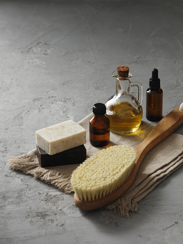 Set of organic beauty products (soap, olive oil and serum) and body brush