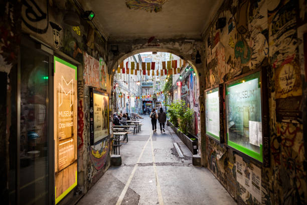 Color image of a wall that has graffiti designs on it.