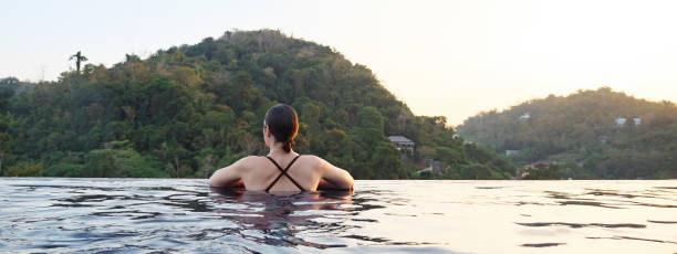 istock brunette t in large outdoor pool 1251358367