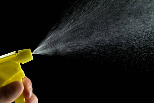 istock Liquid water spray mist from perfume bottle isolated on black. Aerosol splash background. 1251360765