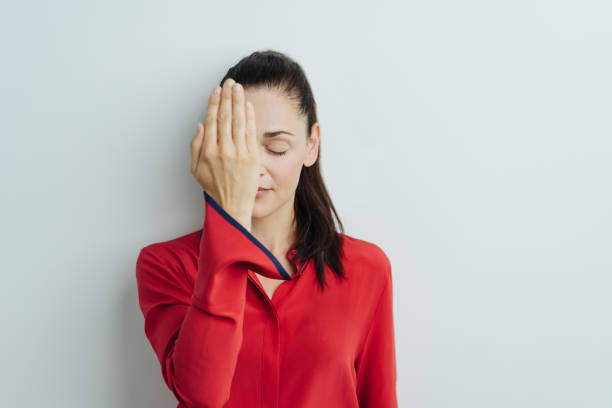 Serene young woman covering one eye
