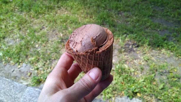 istock A woman`s hand holding ice cream. 1251363228