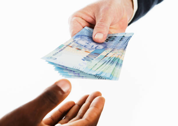 istock Hand passing money to another person in payment 1251363285