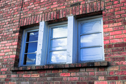 Blue old windows of a brick house