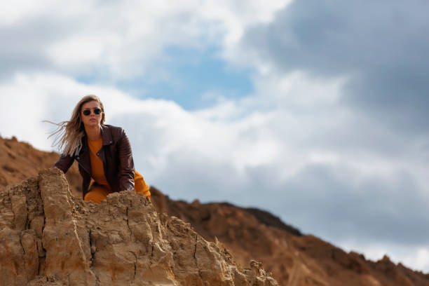 istock Woman hiding and looking from the mountain 1251366412
