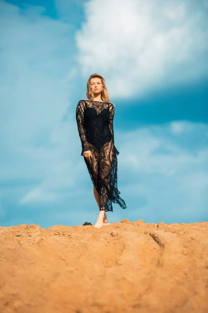 istock Woman walks on sandy ground 1251366440