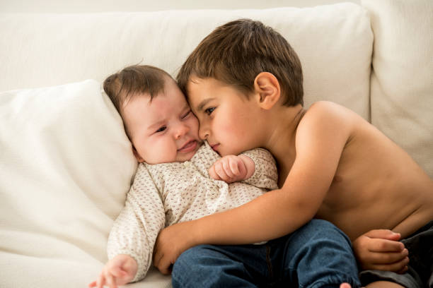 istock Little boy hugging his younger sibling 1251368924