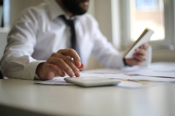 istock Business accounting concept, Business man using calculator with computer laptop, budget and loan paper in office. 1251371842