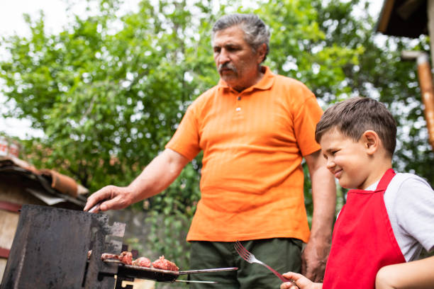istock A young boy barbecuing with his grandpa 1251373408