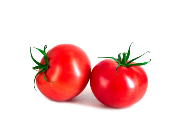 istock Two ripe bright red tomatoes with green tails isolated on white background 1251373686