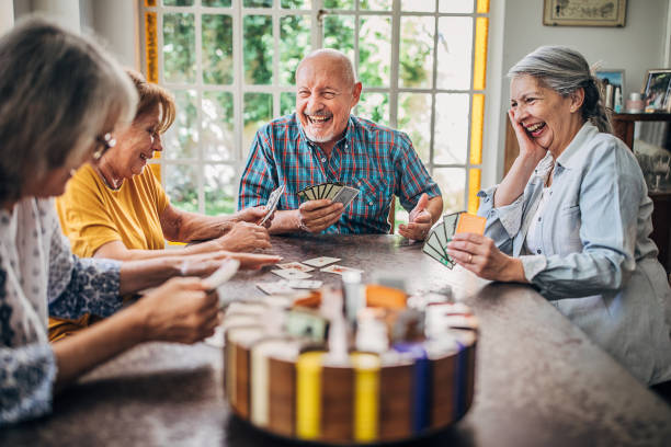 istock Senior friends having fun playing cards 1251373860