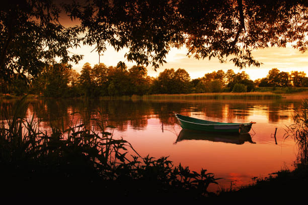 Rowing boat floating over the Elckie Lake waters. Masuria, Poland.