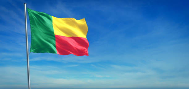 The National flag of Benin The National flag of Benin blowing in the wind in front of a clear blue sky benin stock pictures, royalty-free photos & images