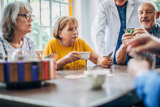 istock Senior people playing cards and having fun in nursing home 1251375135