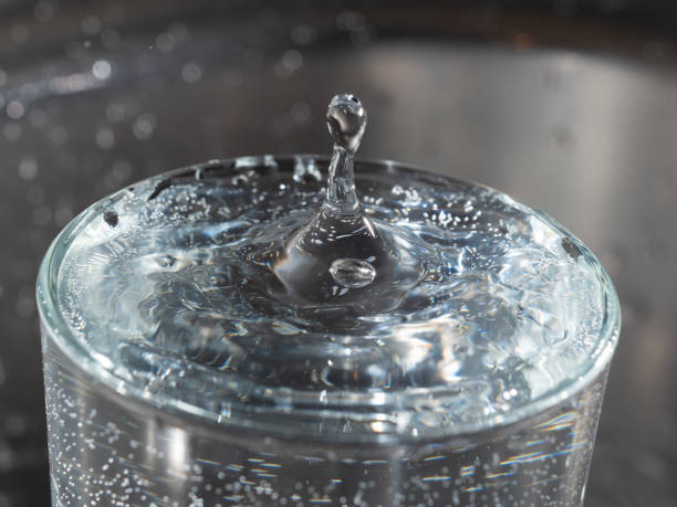 istock A drop of water falling into a glass 1251375936