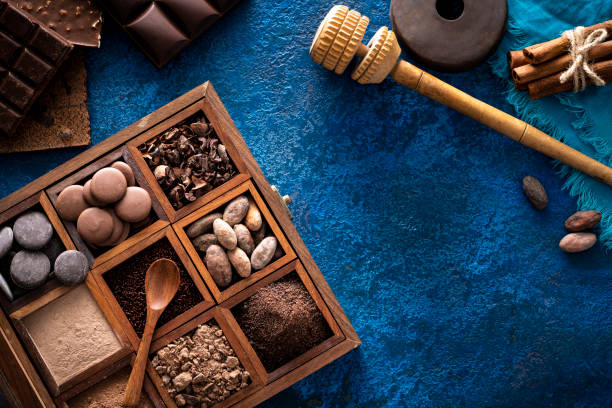 istock Chocolate box with cocoa beans and powder, chololate drops and chocolate beans 1251376556