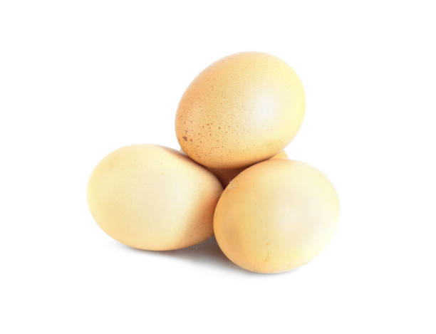 istock Three whole raw in shell beige with dots chicken eggs isolated on white background 1251377897