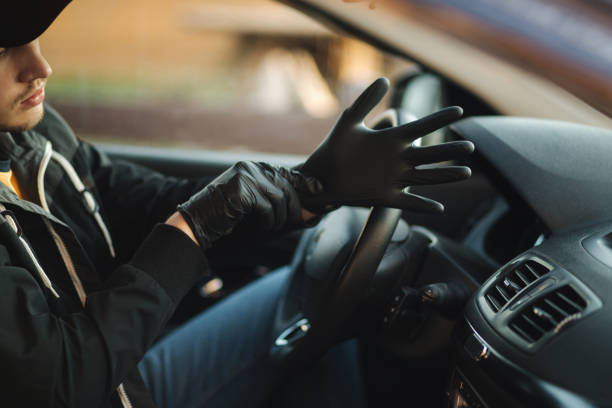 istock Man in car put on black gloves to protect himself 1251380277