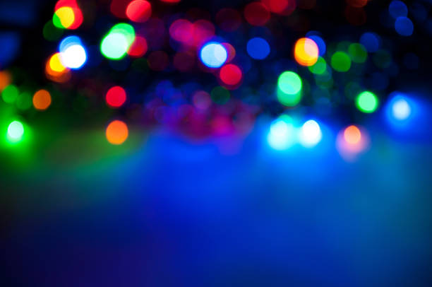 istock Glowing and festive colored light circles created from in camera and lens bokeh. Christmas fairy lights defocused giving a blurred effect. Background for design 1251381687