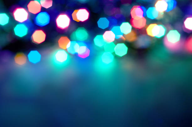 istock Glowing and festive colored light circles created from in camera and lens bokeh. Christmas fairy lights defocused giving a blurred effect. Background for design. 1251381801