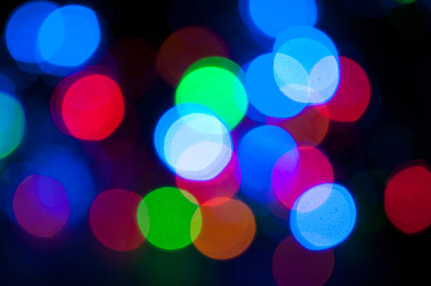 istock Glowing and festive colored light circles created from in camera and lens bokeh. Christmas fairy lights defocused giving a blurred effect. Background for design. 1251381871