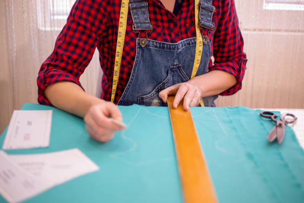 istock The young tailor working near the sewing machine 1251382911