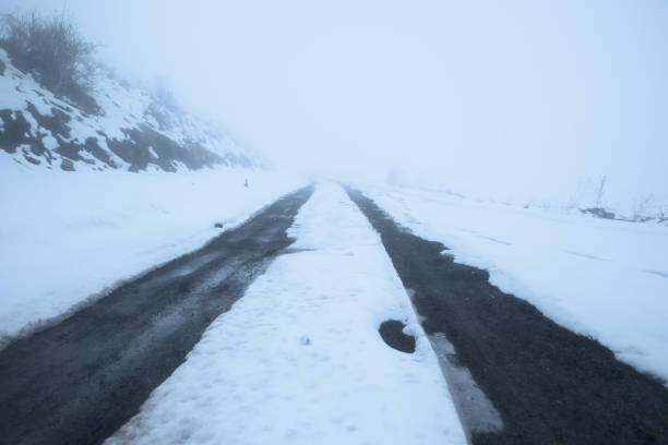 istock winter fog road 1251385906