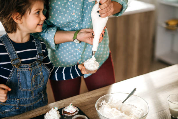istock Mother and son making birthday muffins. 1251393597