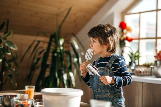 istock Little assistant tasting whipped cream and making funny faces. 1251393638