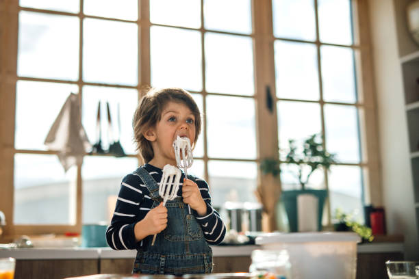 istock Adorable little kid tasting whipped cream. 1251393663