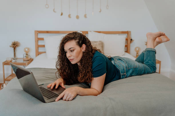 istock Mixed race latin woman using technology at home 1251393769