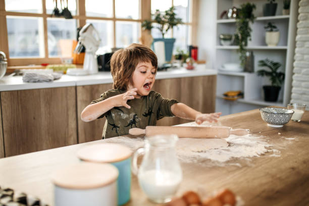 istock Little blond boy having fun in the kitchen. 1251393904
